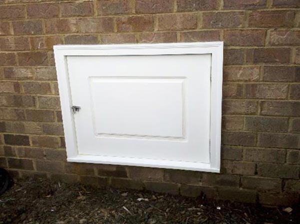 A brand new crawl space door that was installed outside a foundation